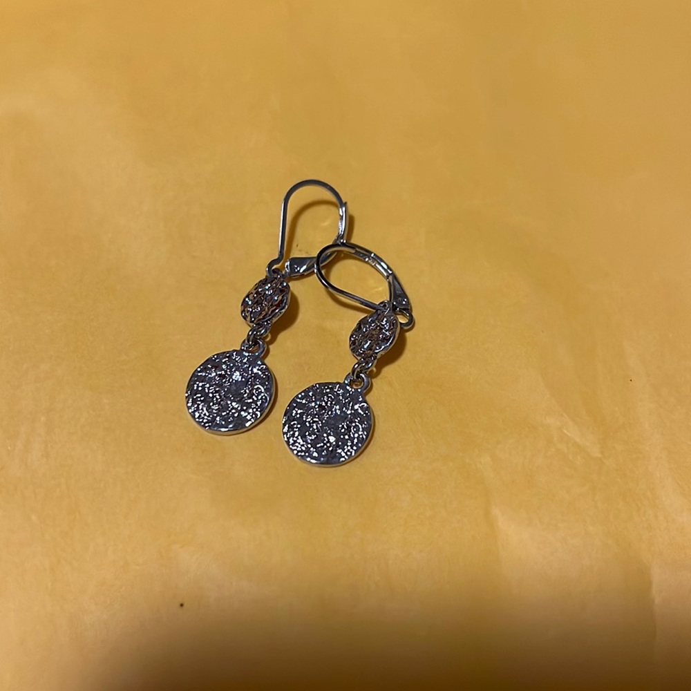 Dangle earrings. Silver in color.